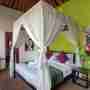 Double Bed With A Green Background Wall