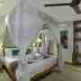Canopied Bed With Buddha Statues Home Decor
