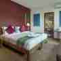 Twin Bedroom With A Red Background Wall